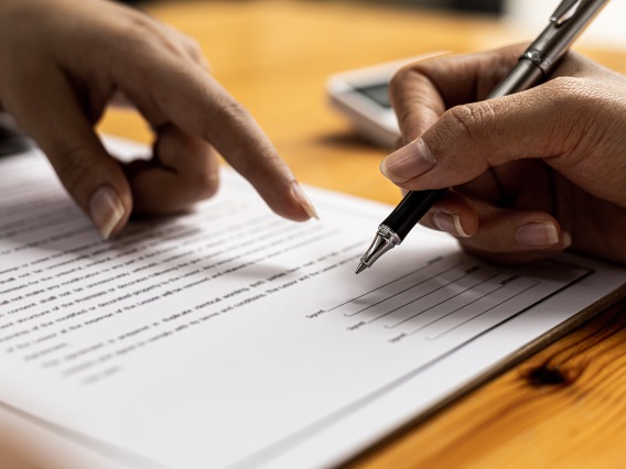 hands signing a contract