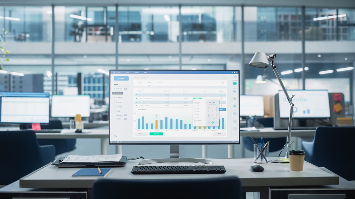 desk with computer screen showing data chart